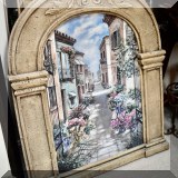 A21. Street scene print in arched frame.